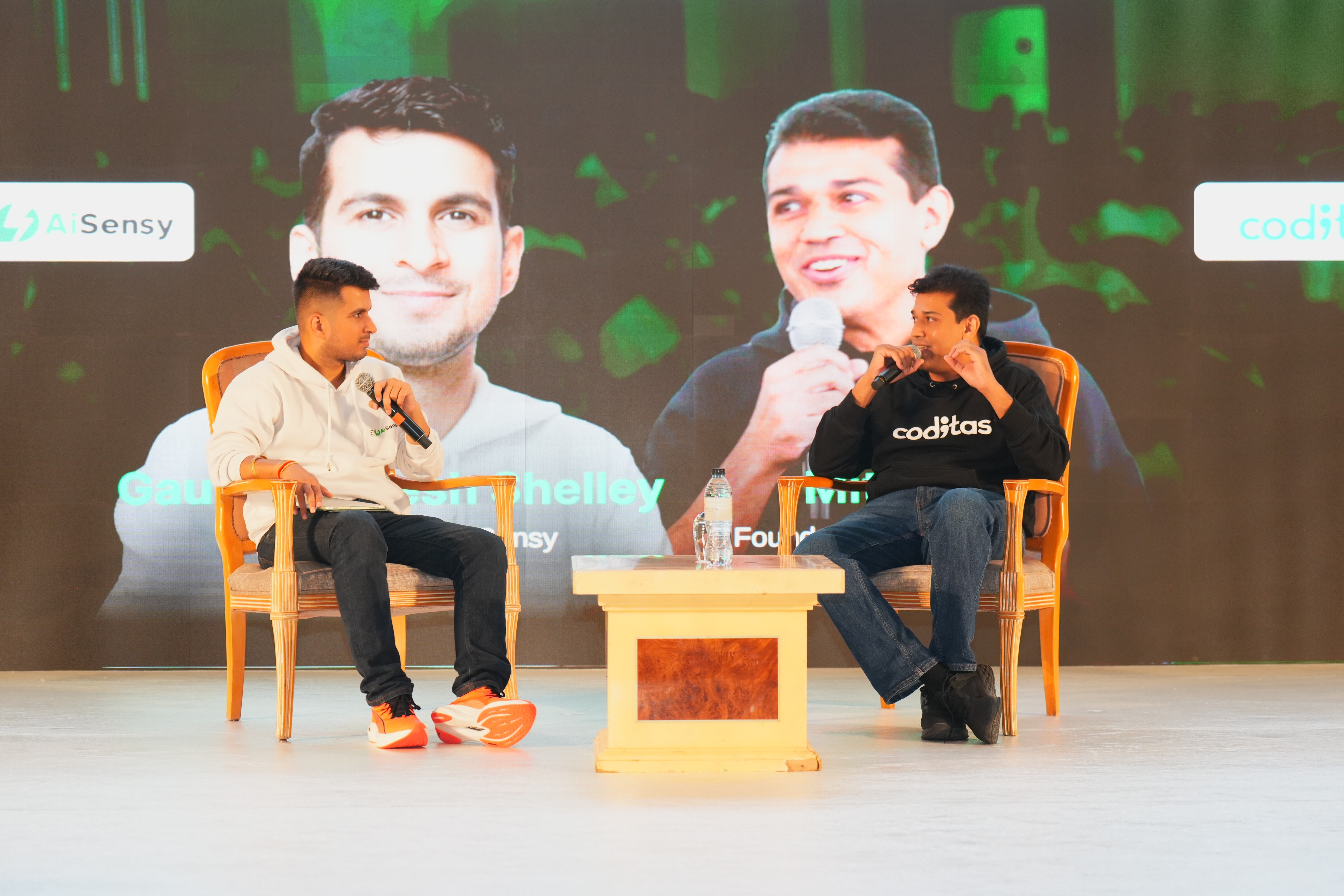 Intimate fireside chat with industry leaders in orange chairs